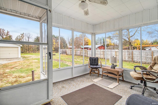 sunroom / solarium featuring ceiling fan and plenty of natural light