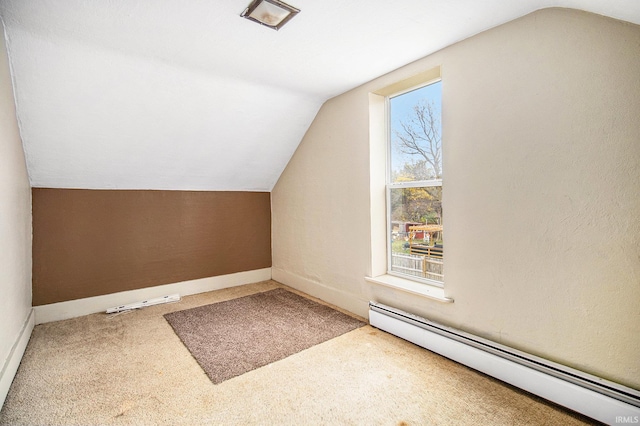 additional living space with carpet, vaulted ceiling, and a baseboard radiator