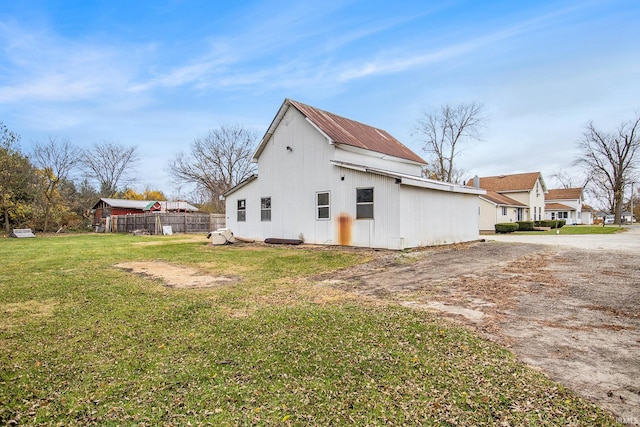 view of side of property with a lawn