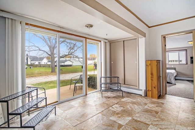 doorway featuring baseboard heating, a healthy amount of sunlight, and crown molding