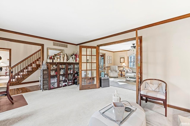 living area featuring carpet flooring, french doors, ornamental molding, and ceiling fan