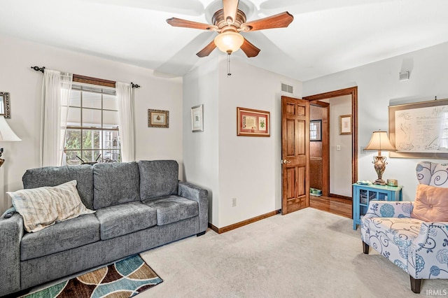 living room featuring light colored carpet and ceiling fan