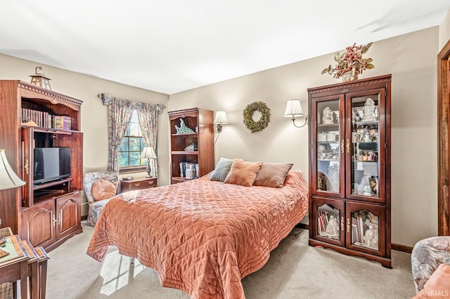 bedroom featuring light carpet