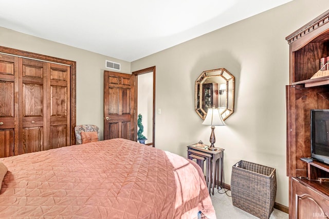 bedroom with light colored carpet and a closet