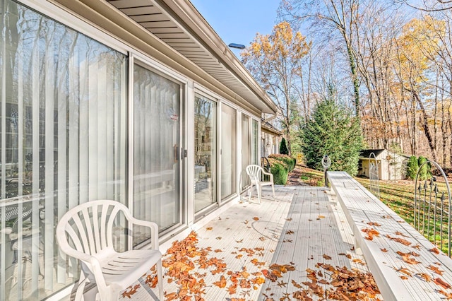 wooden terrace with a storage shed