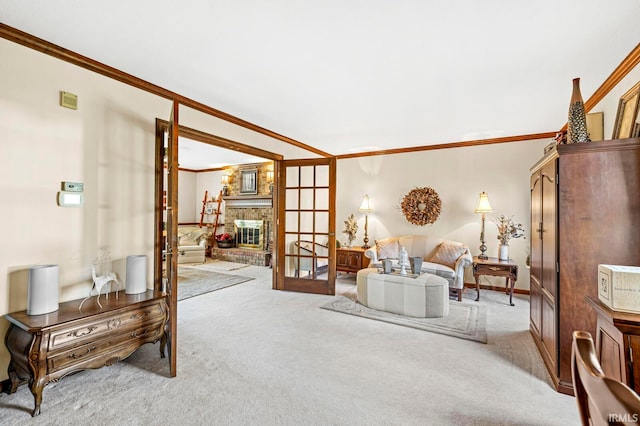 sitting room featuring french doors, light colored carpet, ornamental molding, and a brick fireplace