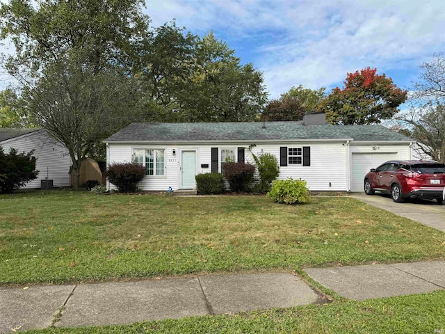 ranch-style house with a garage and a front lawn