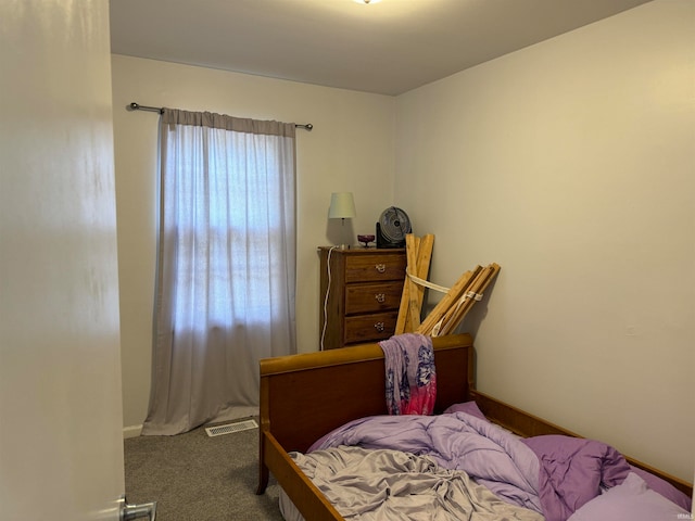 bedroom featuring multiple windows and carpet