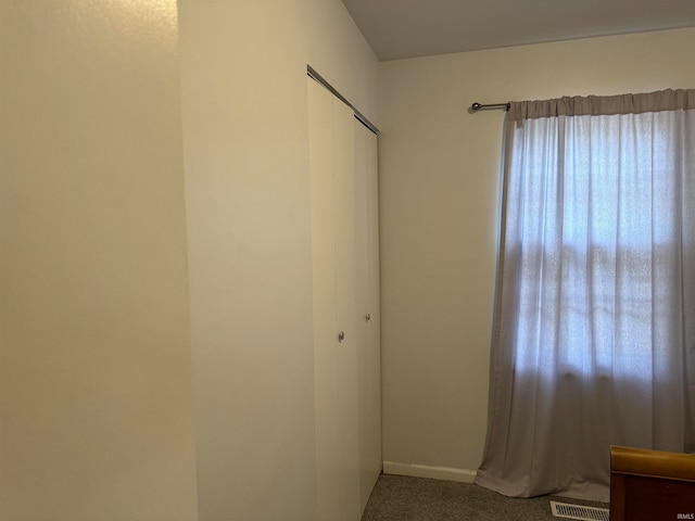 unfurnished bedroom featuring a closet and carpet floors