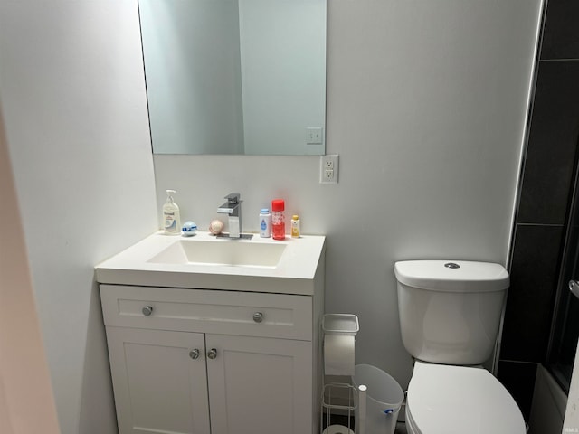 bathroom featuring vanity and toilet