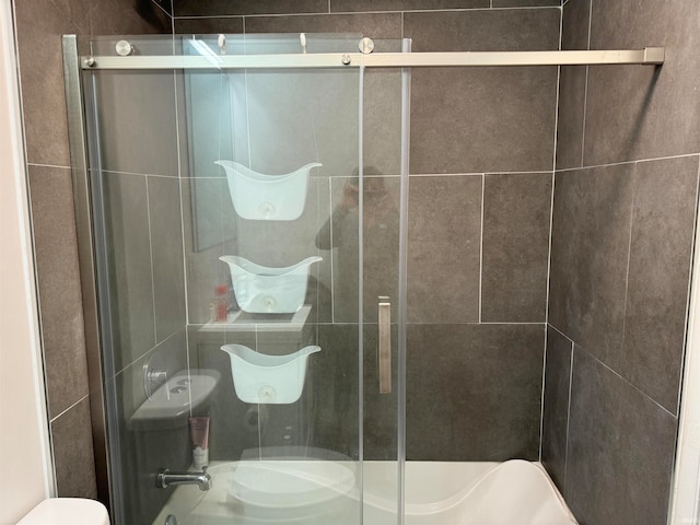 bathroom with toilet and an enclosed shower