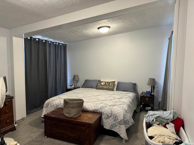 bedroom featuring a textured ceiling and carpet