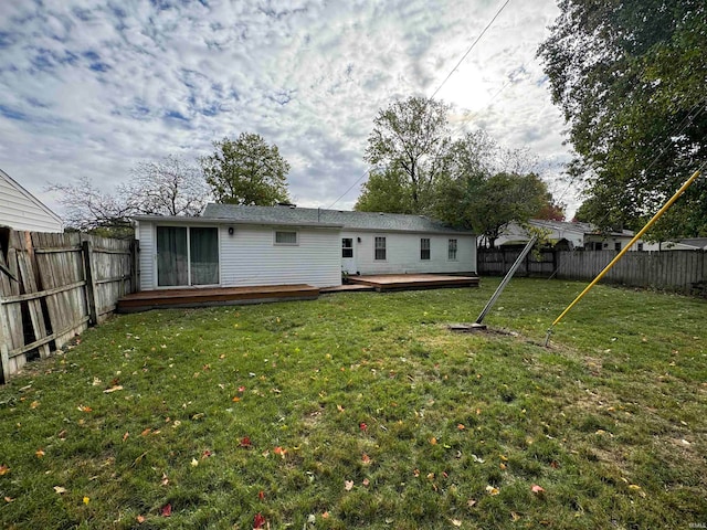 rear view of property featuring a yard