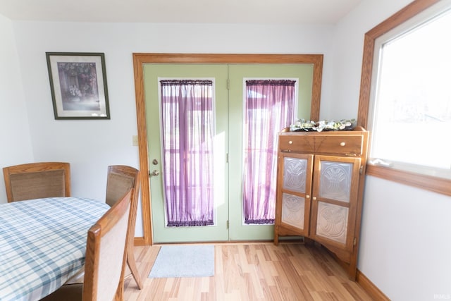 doorway to outside with light wood-type flooring and a healthy amount of sunlight