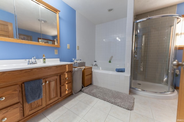 bathroom with independent shower and bath, vanity, and tile patterned floors