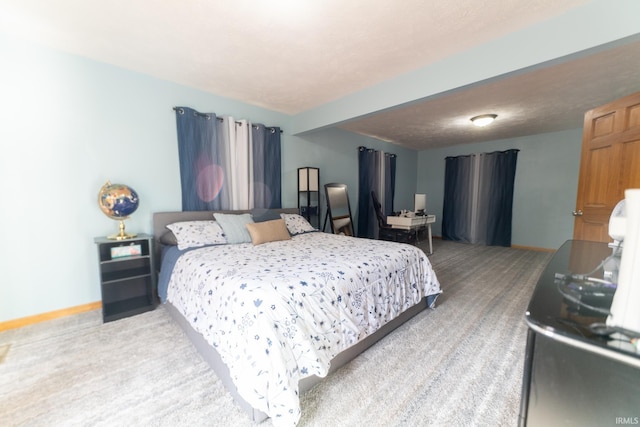 bedroom with carpet floors and a textured ceiling