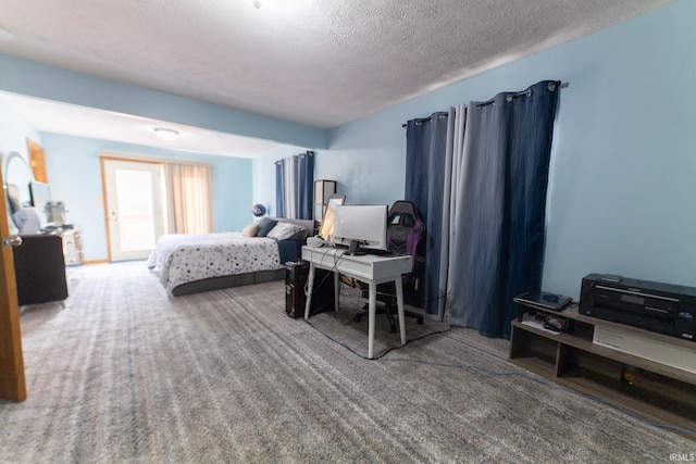 bedroom featuring a textured ceiling and carpet floors