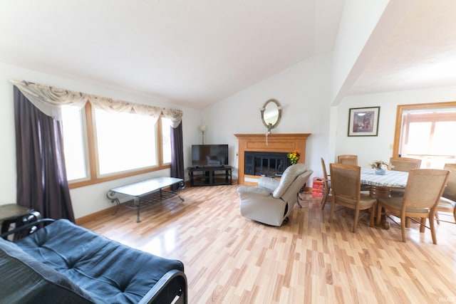 living room featuring light wood-type flooring and vaulted ceiling