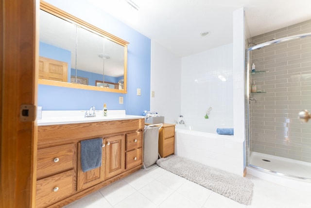 bathroom with shower with separate bathtub, vanity, and tile patterned flooring