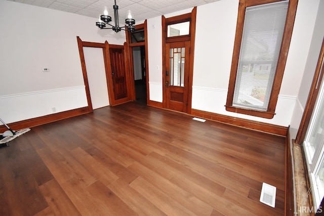 interior space with hardwood / wood-style floors and a chandelier