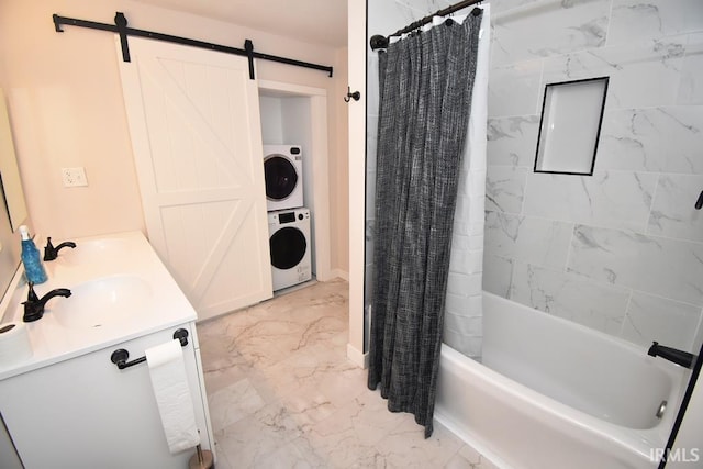 bathroom featuring shower / tub combo with curtain, vanity, and stacked washer / dryer