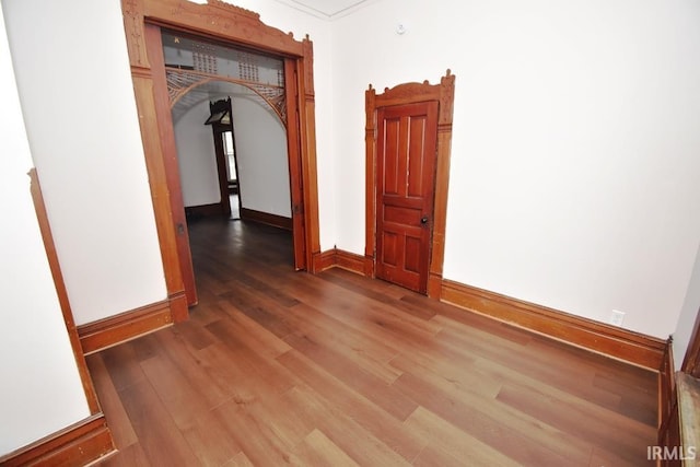 corridor featuring hardwood / wood-style flooring and crown molding