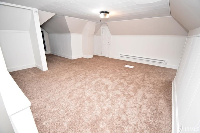 additional living space featuring a baseboard heating unit, carpet, and lofted ceiling