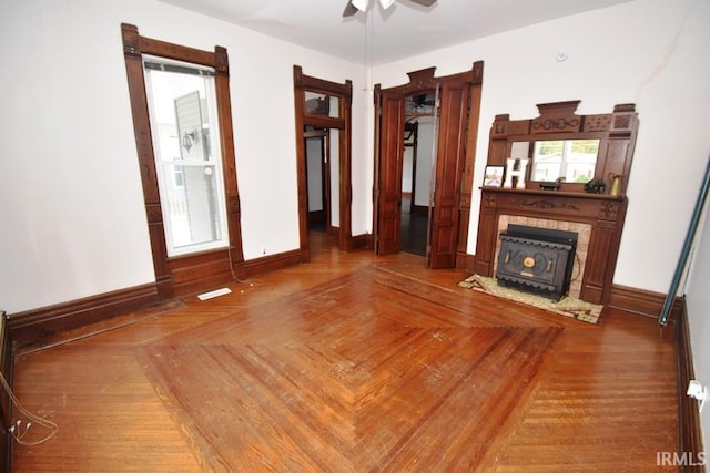 unfurnished living room with parquet flooring and ceiling fan