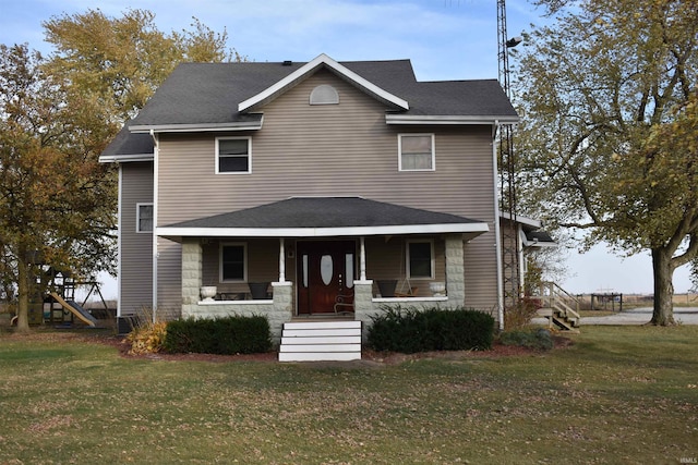 view of front facade featuring a front yard and covered porch