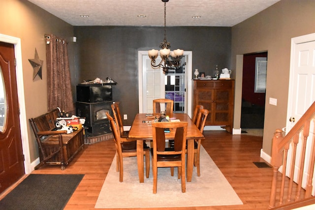 dining area featuring a notable chandelier and light hardwood / wood-style floors