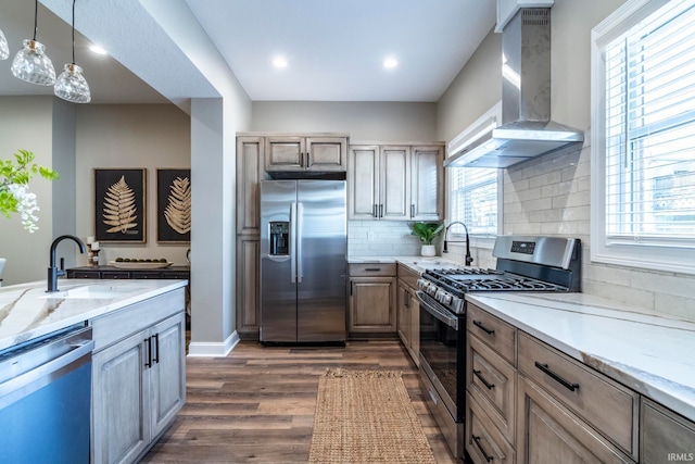 kitchen featuring a wealth of natural light, wall chimney exhaust hood, dark hardwood / wood-style floors, and appliances with stainless steel finishes