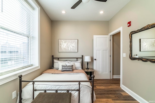 bedroom with ceiling fan and dark hardwood / wood-style floors