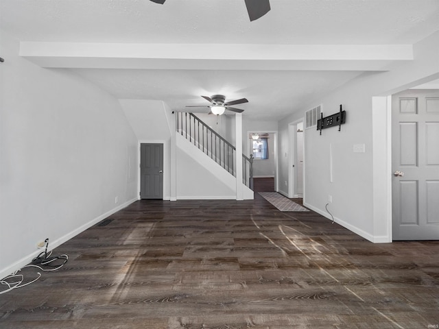 unfurnished living room featuring dark wood-type flooring and ceiling fan