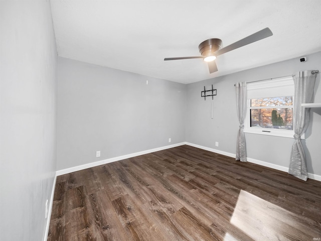 empty room featuring ceiling fan and dark hardwood / wood-style flooring