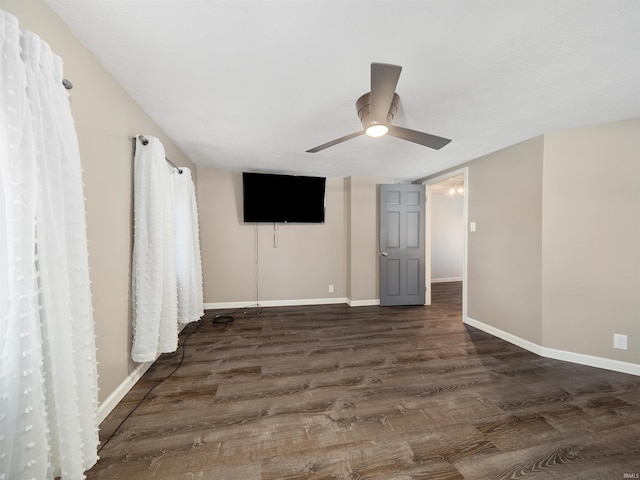 unfurnished room with dark hardwood / wood-style floors and ceiling fan