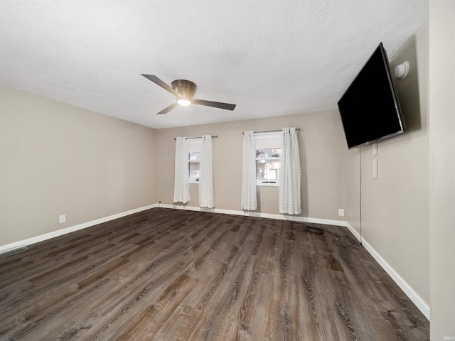 unfurnished room with ceiling fan, dark hardwood / wood-style floors, and a textured ceiling