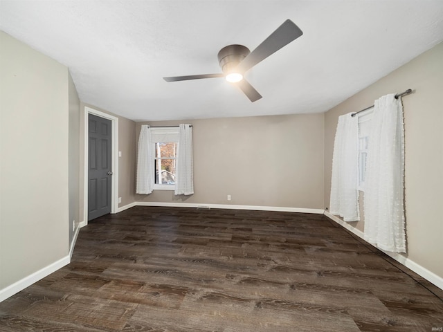 spare room with dark wood-type flooring and ceiling fan