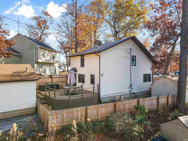 rear view of house featuring a deck