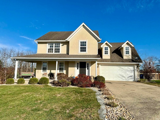 view of front of property with a porch, a front yard, and a garage