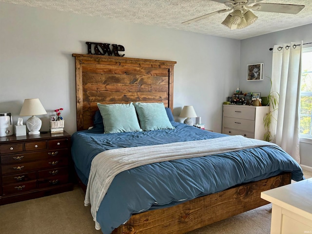 bedroom featuring ceiling fan, a textured ceiling, and light carpet