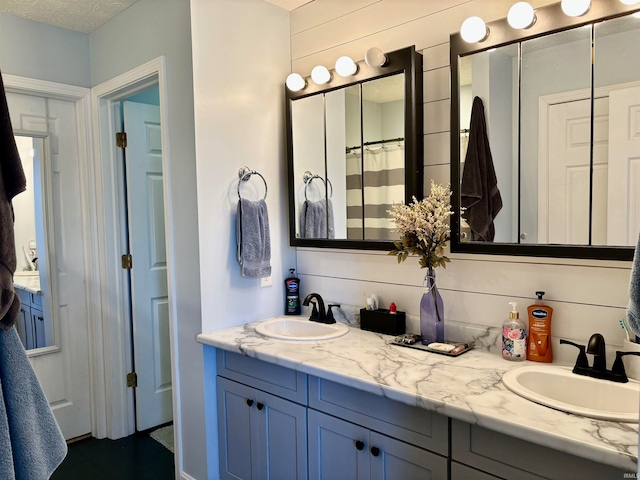 bathroom with vanity and a textured ceiling