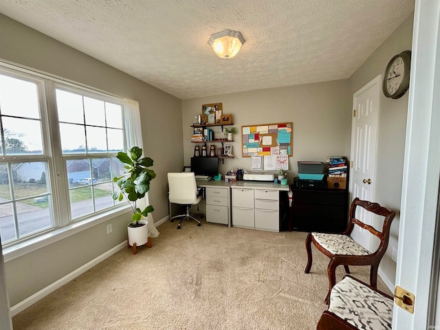 home office with light colored carpet, a textured ceiling, and built in desk