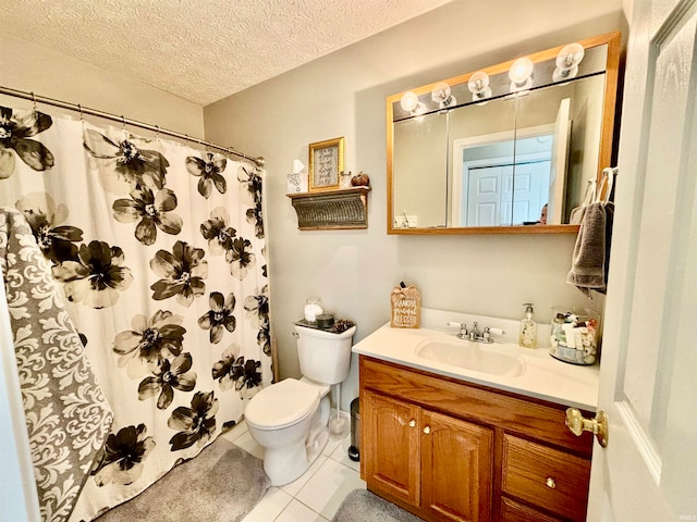 bathroom featuring a shower with curtain, a textured ceiling, vanity, tile patterned floors, and toilet