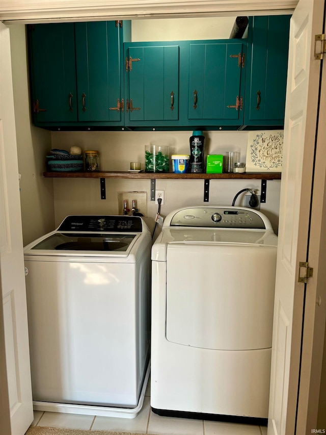 washroom with separate washer and dryer, cabinets, and light tile patterned floors