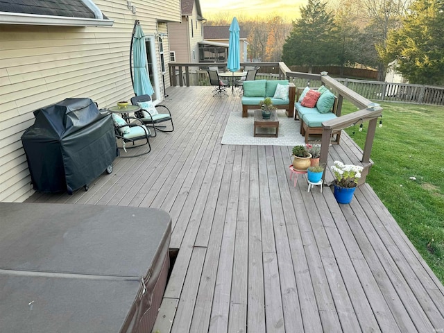 deck at dusk featuring outdoor lounge area, a lawn, and a grill