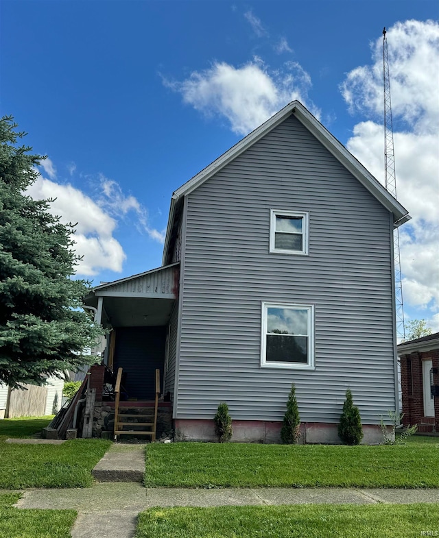 view of property exterior with a yard