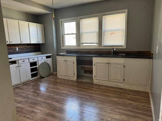 kitchen featuring a textured ceiling, dark hardwood / wood-style floors, and sink