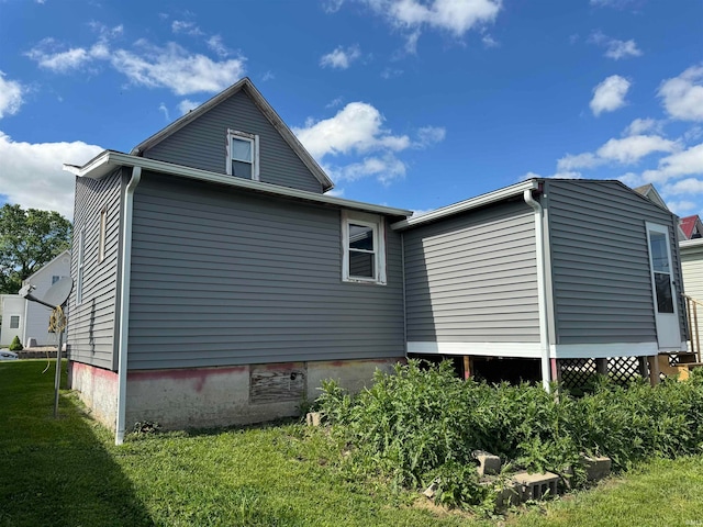 view of home's exterior with a lawn