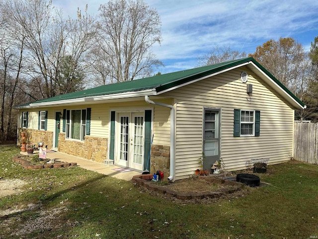 back of property featuring a yard