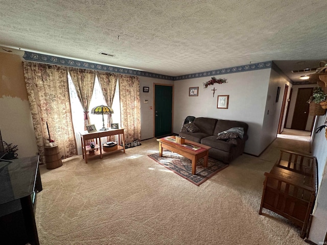 living room featuring a textured ceiling and carpet floors